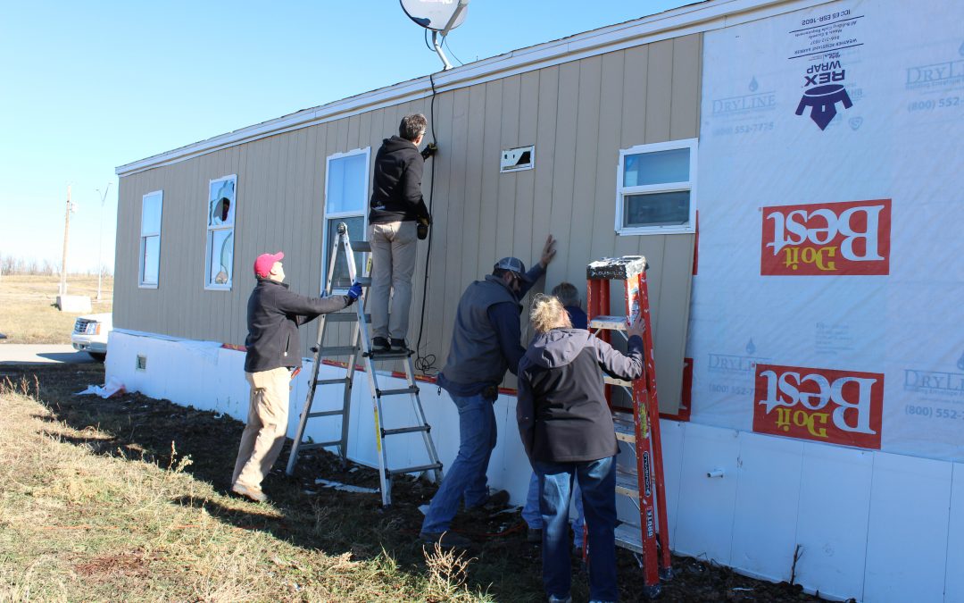volunteers working on trailer home