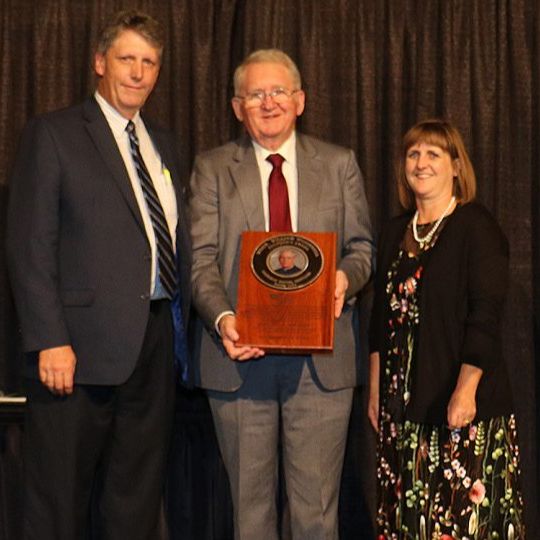 Don Barnett standing with award