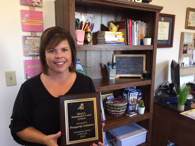 Rittberger standing with award